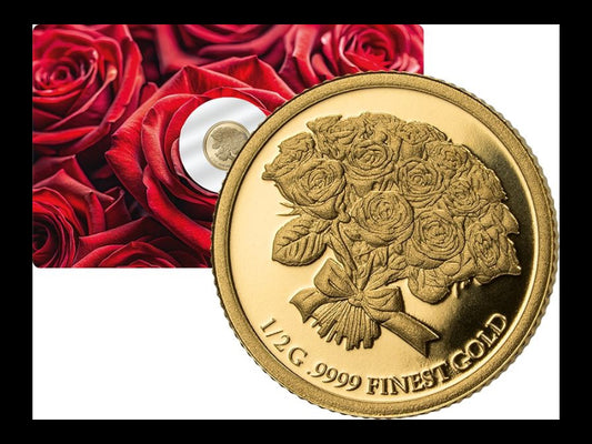 Gold coin with rose design and '1/2 G. 9999 FINEST GOLD' text, placed on a background of red roses.