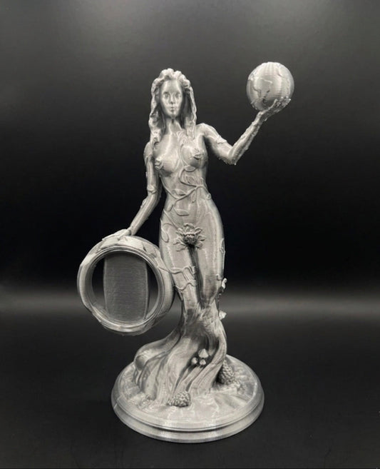 Statue of a woman holding a sphere against a dark background for coin display