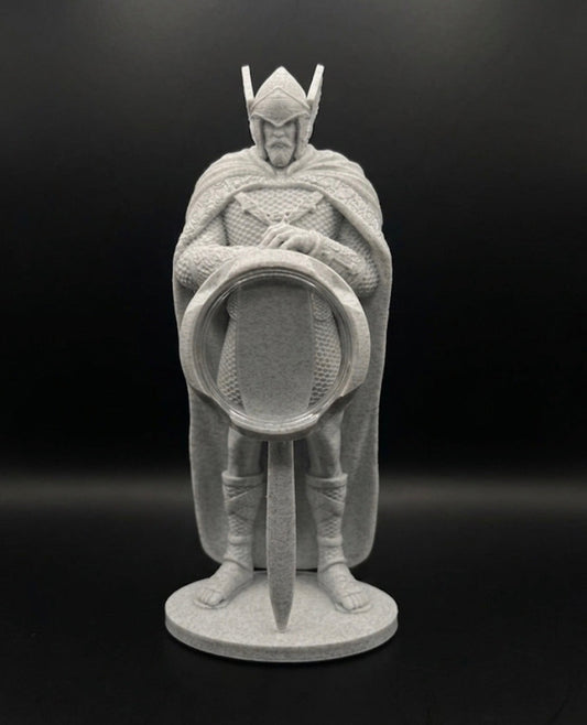 Statue of a warrior holding a sword and shield on a black background